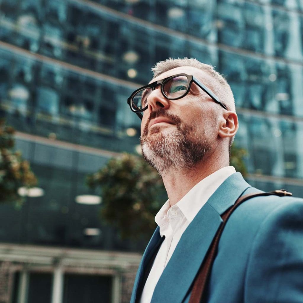 Business professional walking through a city street in the morning.